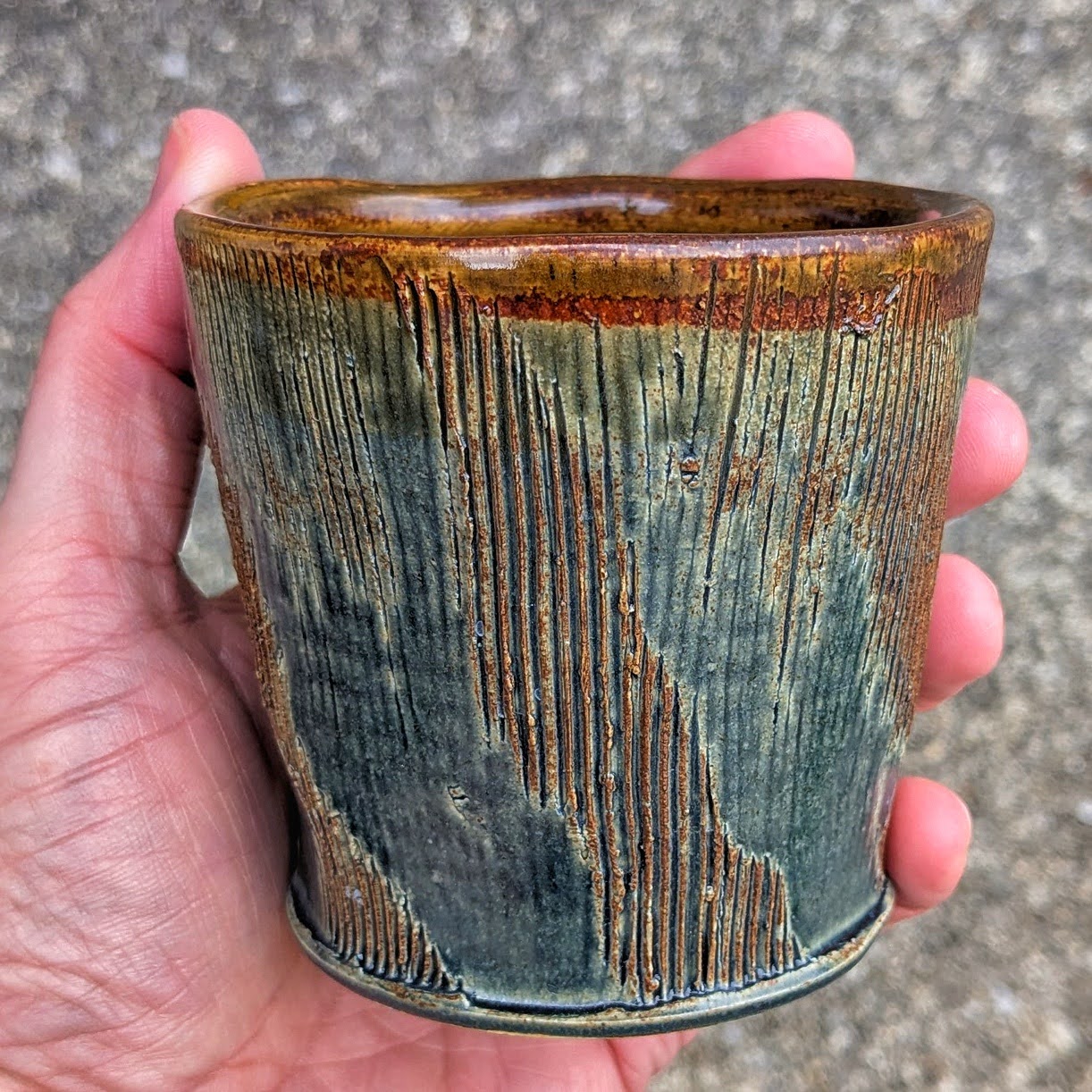 Textured Green and Brown Cup in the Hand
